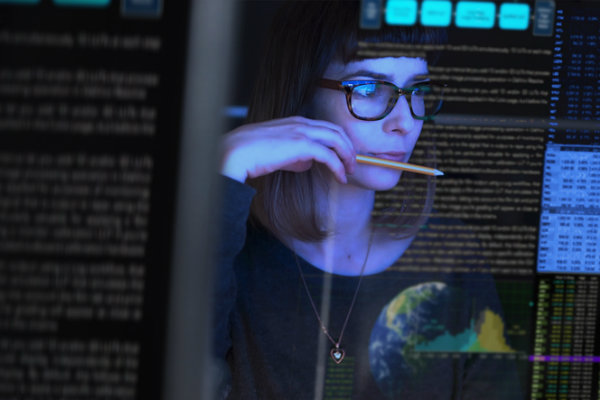 A woman looks at a computer screen