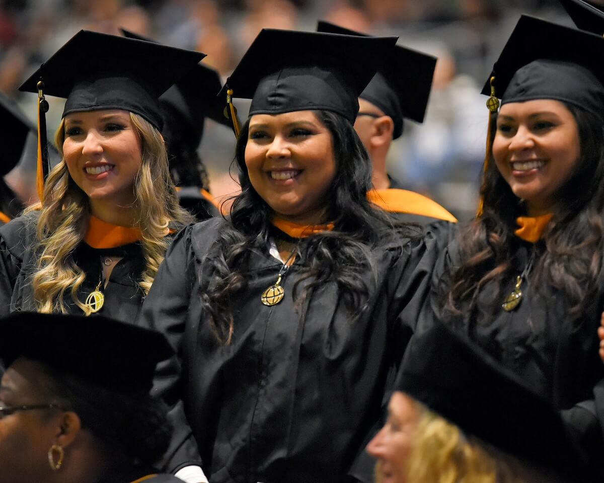 Purdue Global graduates in caps and gowns