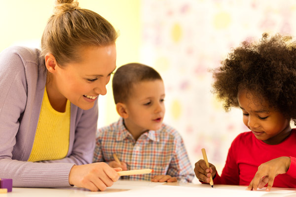 A counselor works with two children