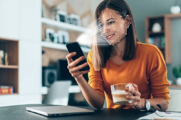 Smart phone scanning woman's face for biometric information