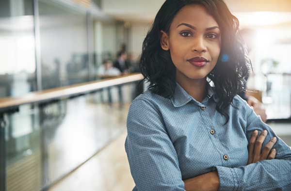 A female business owner stands in an office