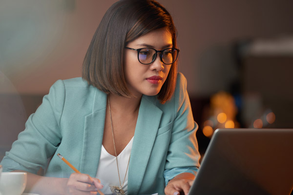 A woman looks at a laptop