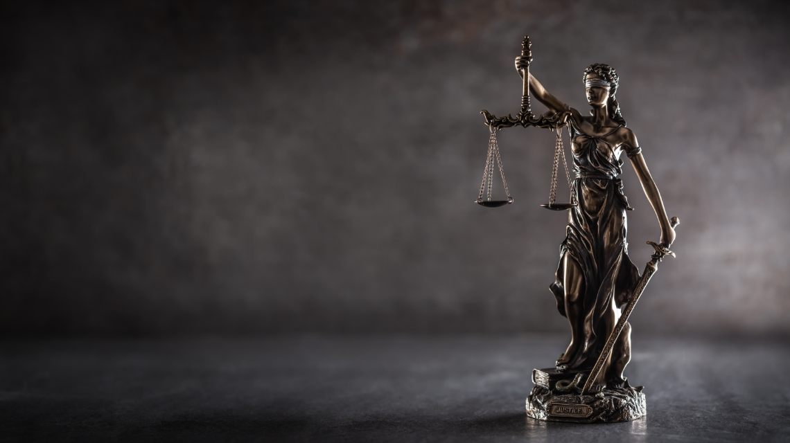 Lady Justice statue holding scales and a sword.