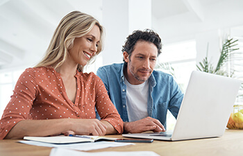 two students looking at a laptop together