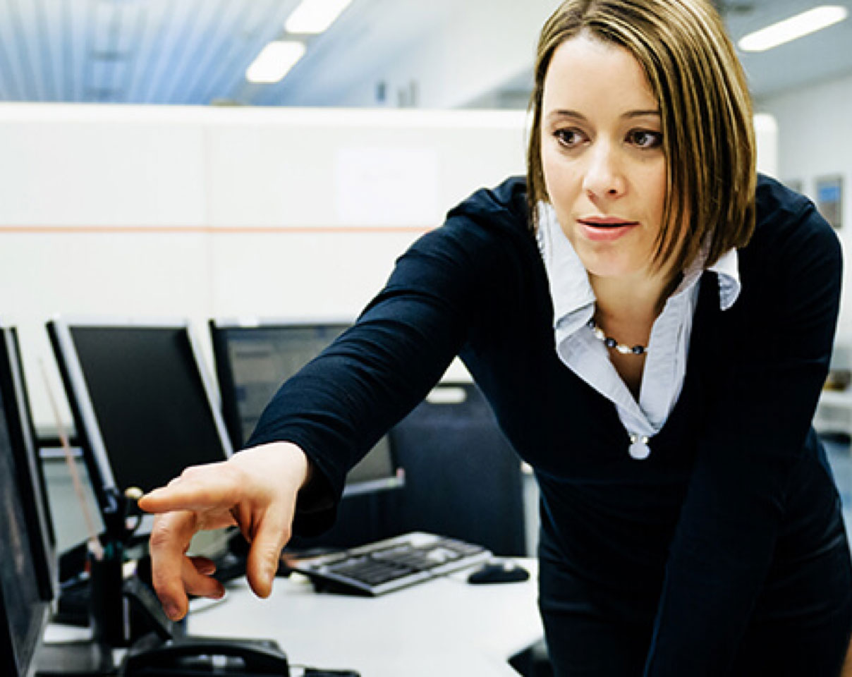 Professional pointing at information on a computer screen