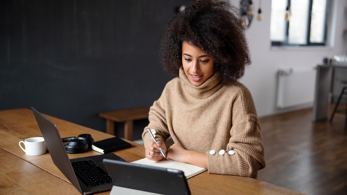 A woman working on her laptop.