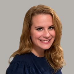 Woman in a black shirt on a gray background.
