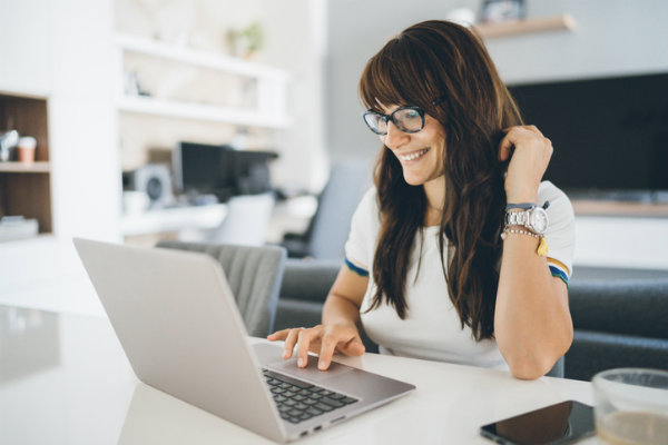 Woman on laptop smiling