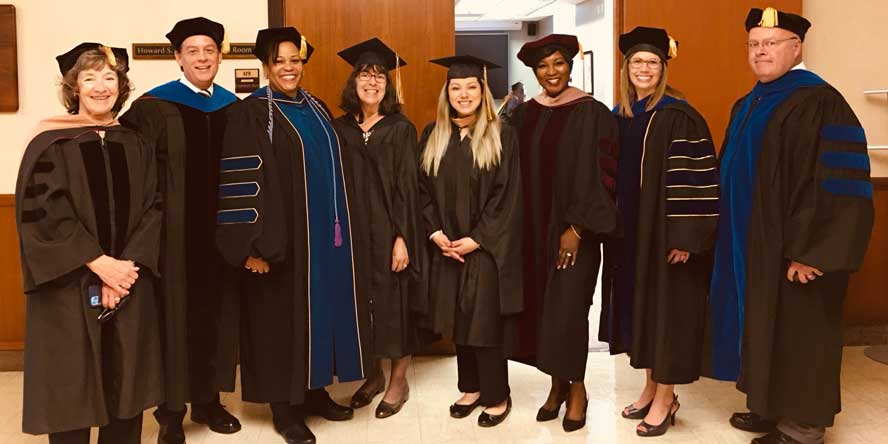 With Purdue Global professors at commencement ceremonies. (Photo provided) 