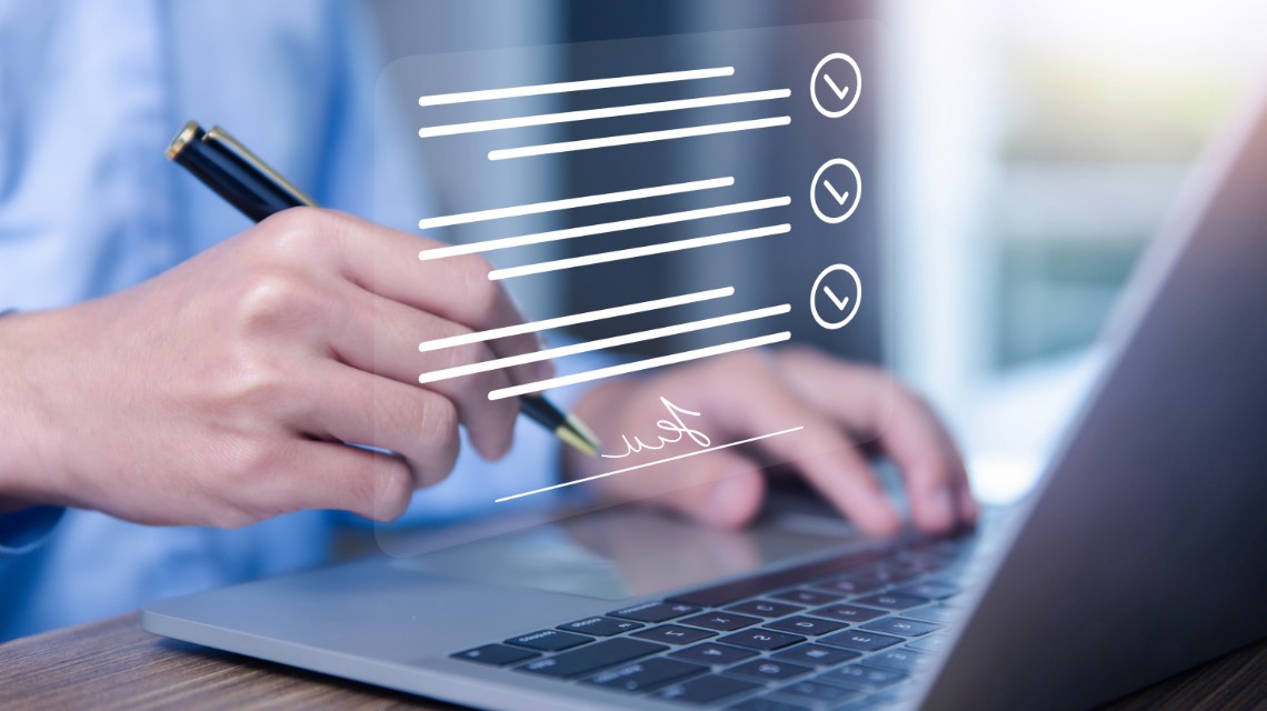 A man using a stylus to sign a digital document.