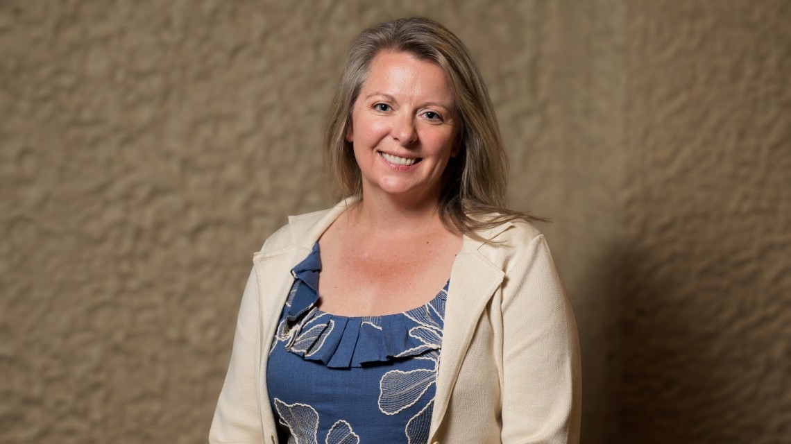 Cap: Purdue Global Law School alumna Abby Strehle looks forward to implementing knowledge gained through the Rural Practice Academy into her practice. (Purdue Global photo/John Underwood)
Alt: Abby Strehle stands smiling in front of a wall.
