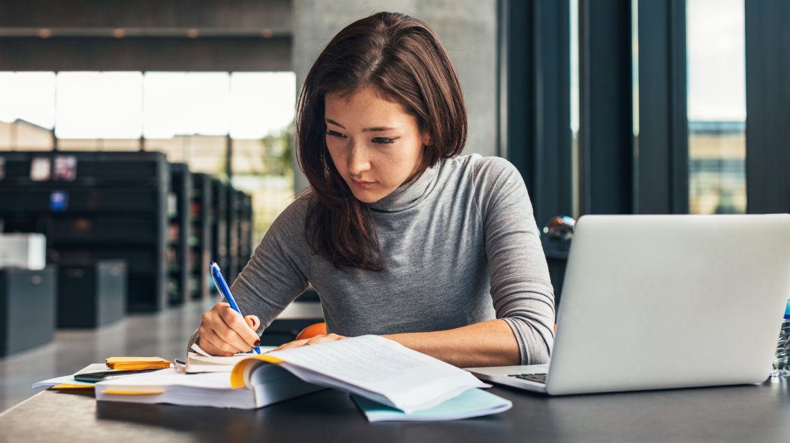 An adult female student working on an assignment for her online college course.