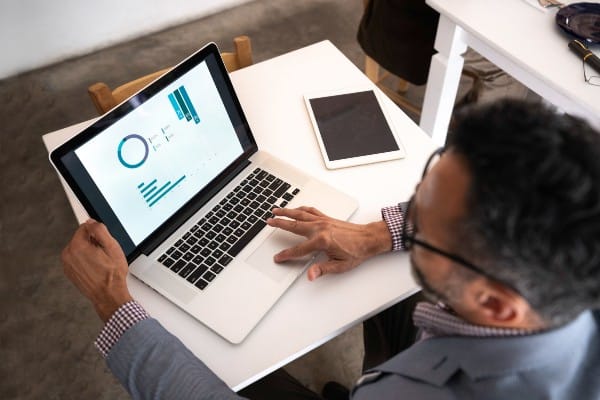 Businessman looking at data charts on his laptop