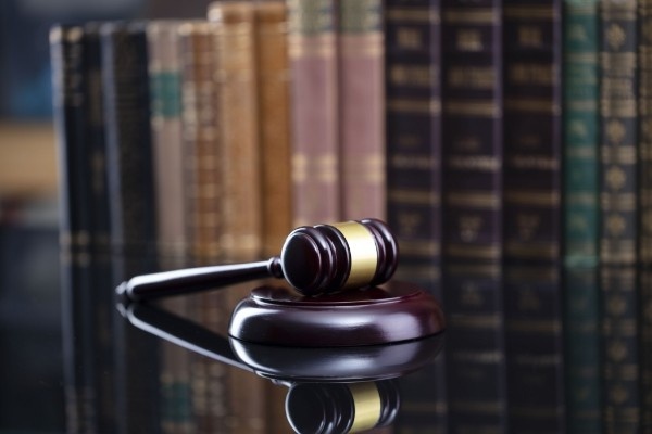 Justice's gavel with stacked legal books in the background