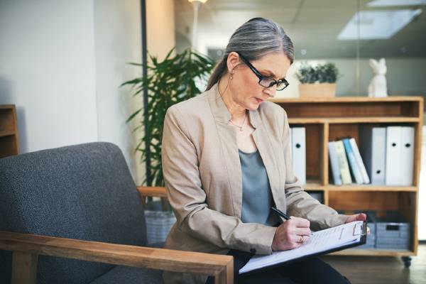 An educational researcher studies educational interventions and learning processes in her office.
