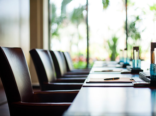 Empty legal conference room with legal pads and pens on a conference table