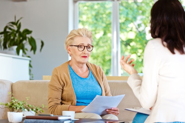 Worried senior woman speaking with a professional