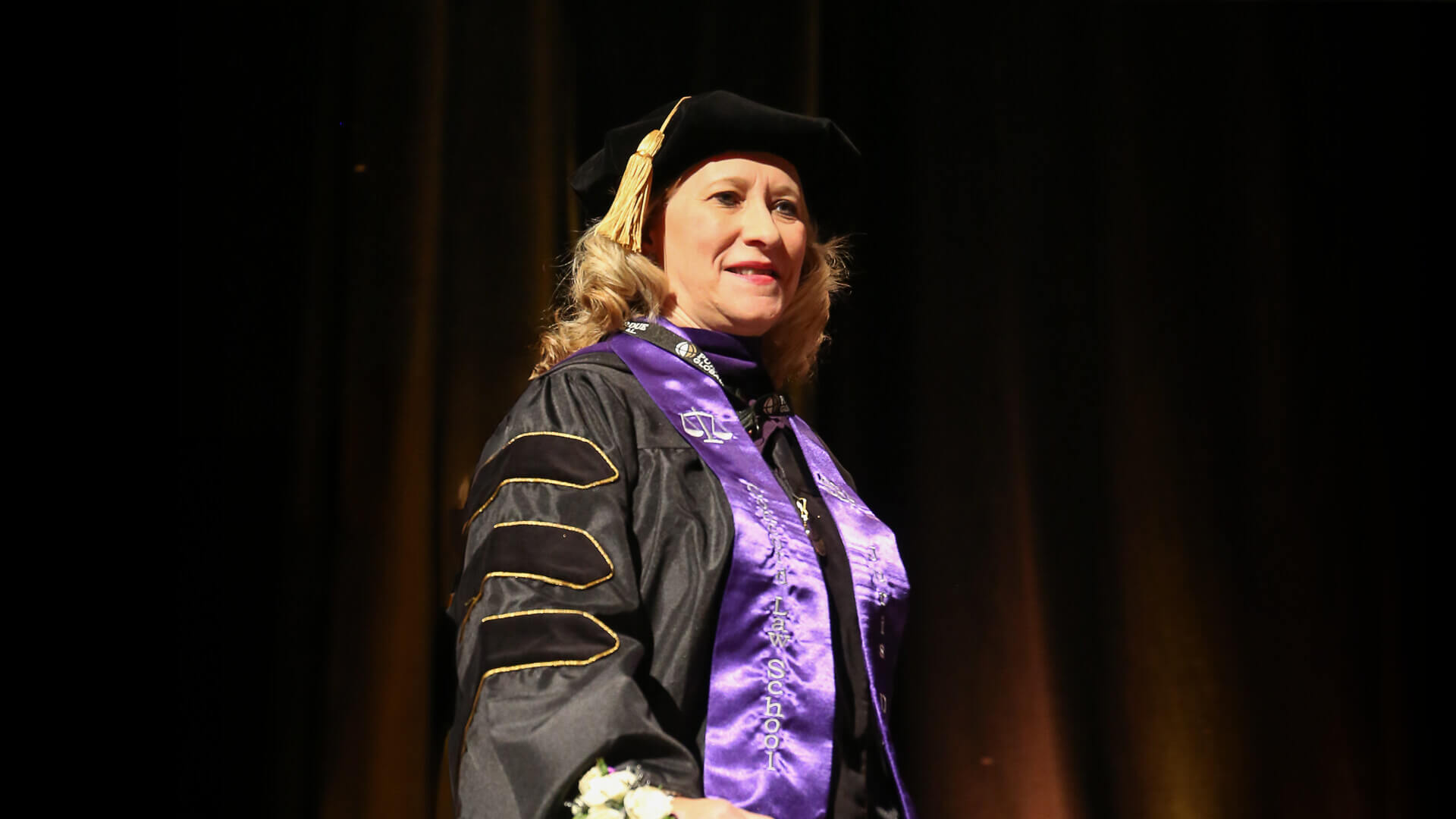 Kerry Koziol in cap and gown at Purdue Global graduation