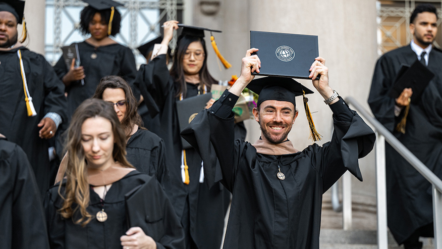 A Purdue Global graduate celebrates at commencement.