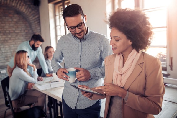 A project manager discusses a project plan with a team member.