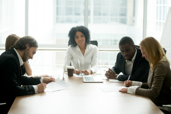 Lawyers and clients around a table practicing mediation and alternative dispute resolution