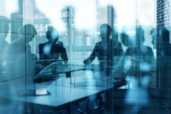 A hazy picture of people meeting in an office represents corporate personhood