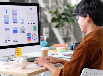 professional working on ux designs on a computer