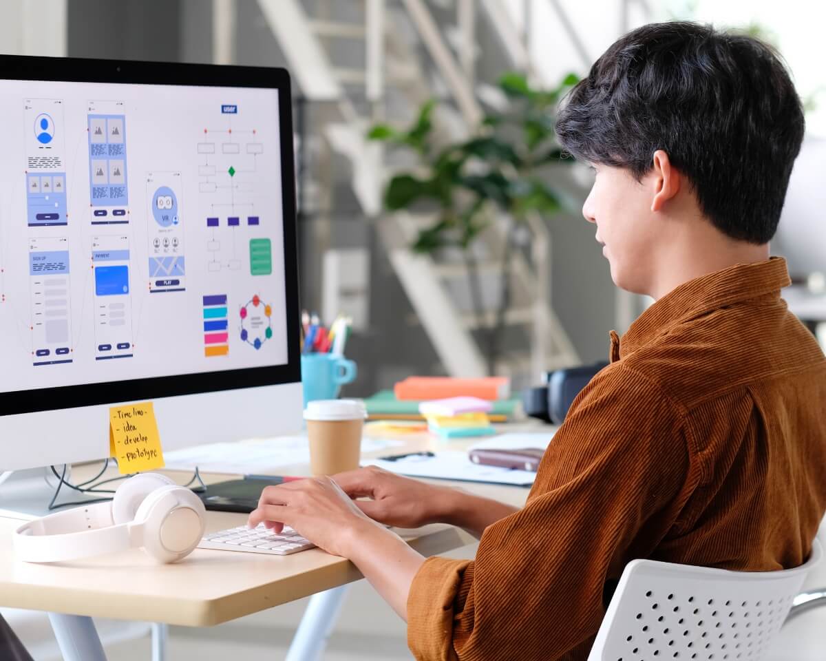 professional working on ux designs on a computer
