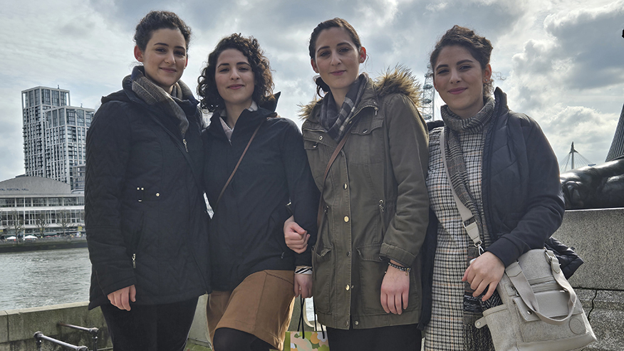 The Minaise sisters standing in front of the River Thames in London