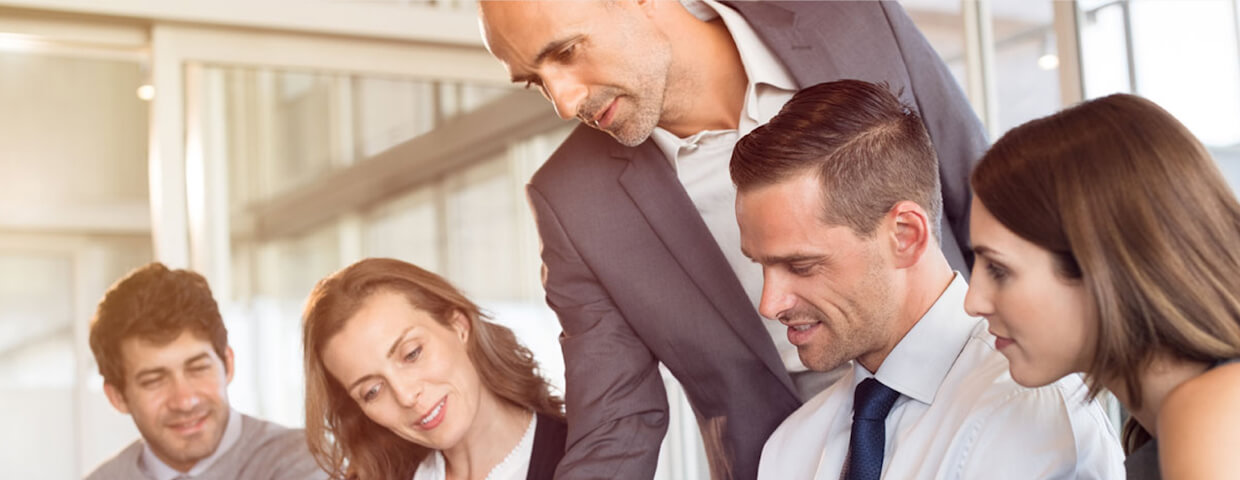 Group of professionals looking at a document and smiling