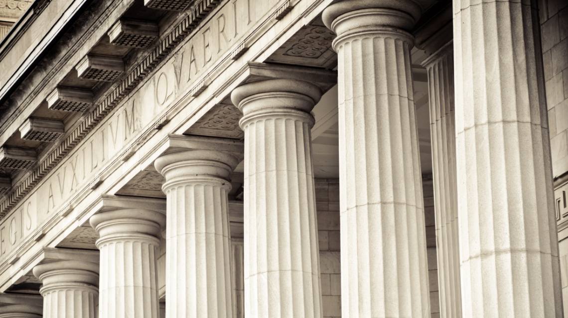 Close-up view of a courthouse building with stone columns.
