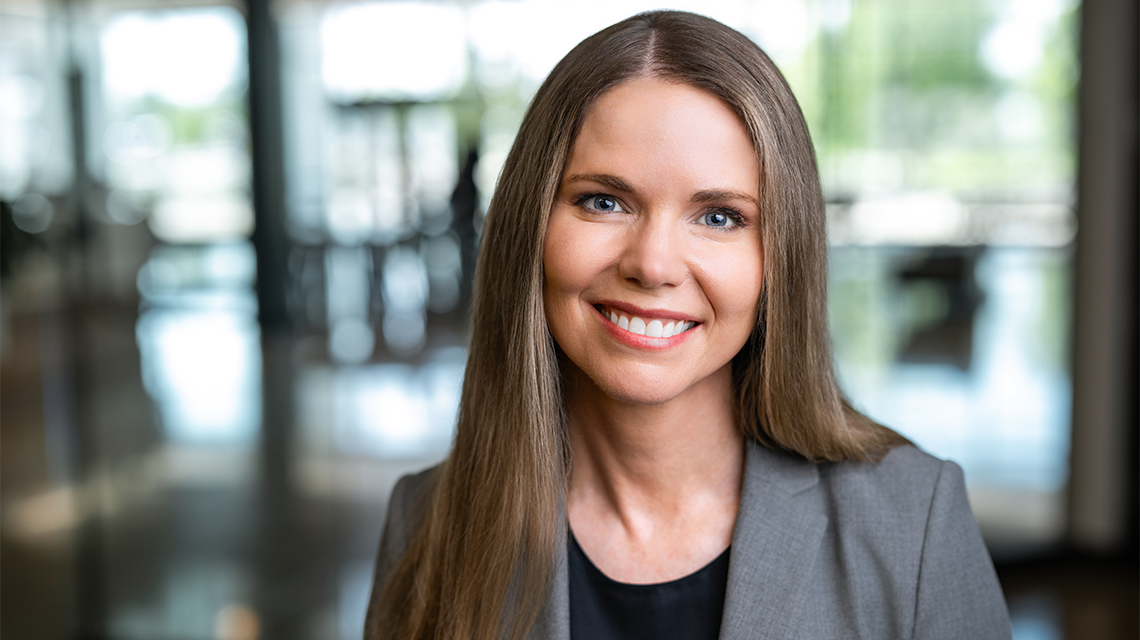 Cap: Jennie Sanders, Purdue Global's new chief academic officer. (Purdue Global photo/Kelsey Lefever)
Alt: Woman with long hair, wearing a gray blazer and black shirt, smiles at camera.