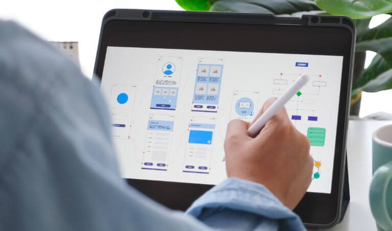 professional working on ux designs on a laptop