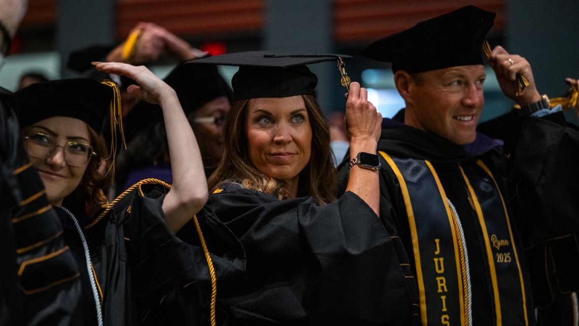 Cap: Purdue Global graduates celebrate during a commencement ceremony in May 2026. (Purdue University photo/Kelsey Lefever)
Alt: A group of graduates in their caps and gowns