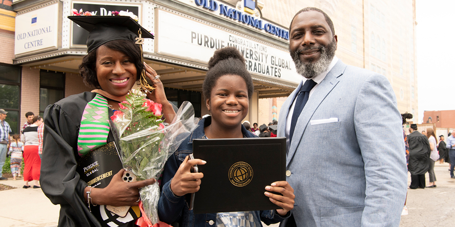 Sheila Taylor celebrates with daughter McKenzie Clark and husband Nate Clark outside Purdue University Global’s spring commencement at Indianapolis’ Old National Centre on May 21, 2022. (Purdue University photo/John Underwood)