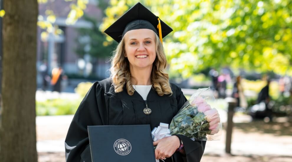 Purdue Global graduate Angel Riley in cap and gown