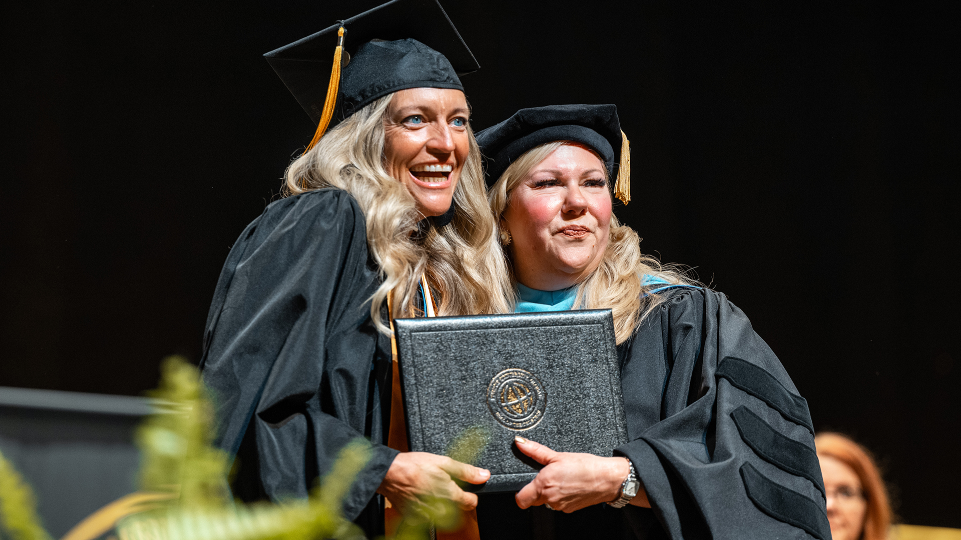 Leighellen Landskov accepting her diploma at graduation