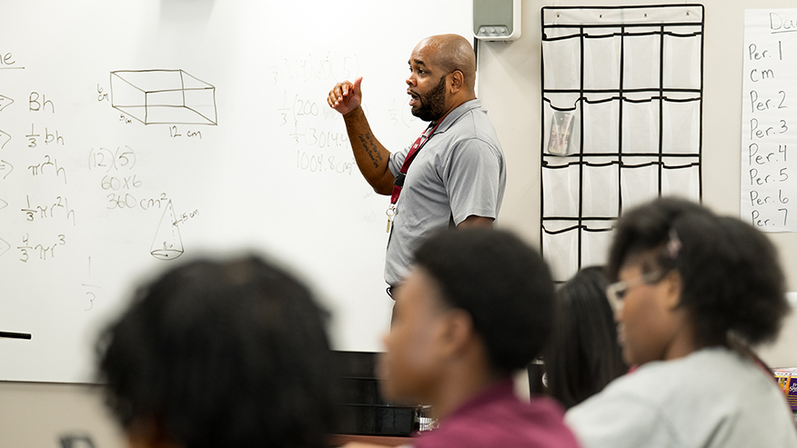 Donald Yates III works with his students during honors geometry at Charles A. Tindley Accelerated School in Indianapolis. (Purdue Global photo/John Underwood)