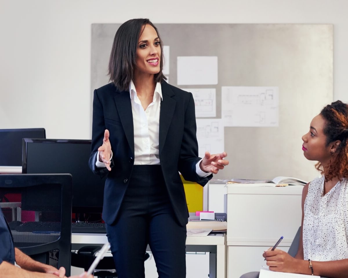 Business professional presenting to colleagues in a conference room