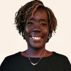 A woman in a black shirt with a necklace on a white background.