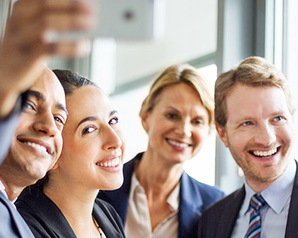 Group of professionals pose for a selfie