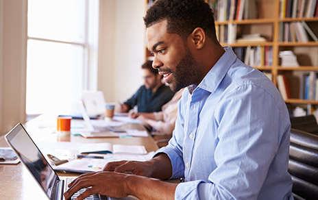 man working on laptop in library
