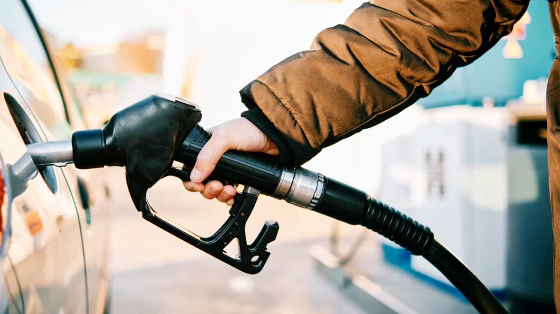 A person filling up their gas tank.