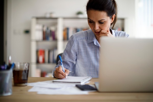 A woman studying and taking notes.