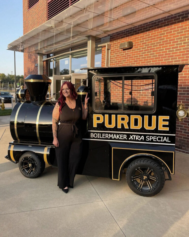 Melton poses with the Boilermaker Xtra Special during Purdue Global’s graduation weekend. (Photo provided)