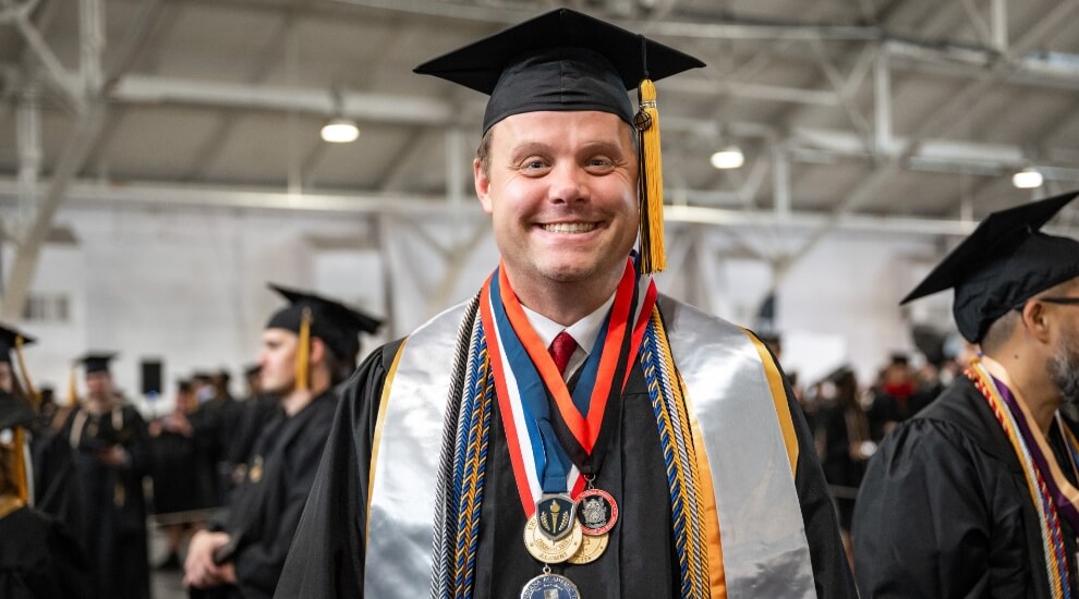 Purdue Global graduate Kurtis Ashton in cap and gown
