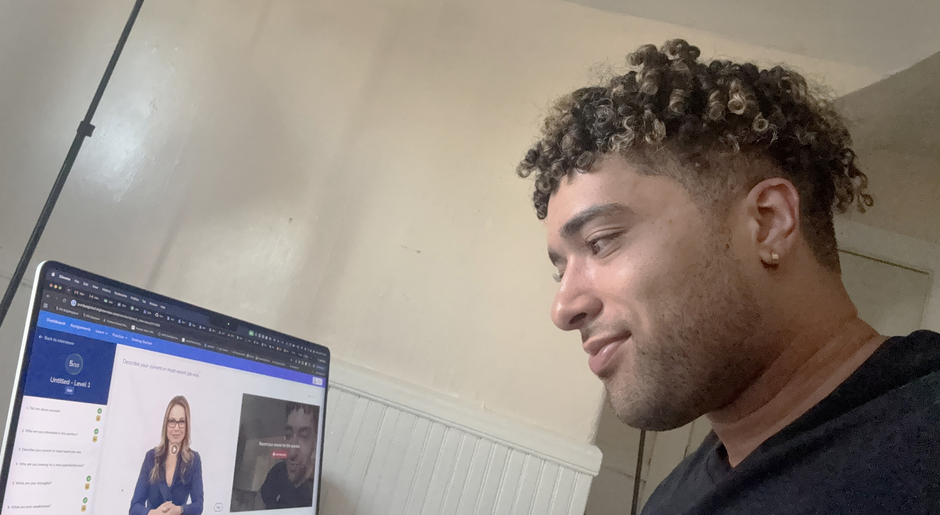 Cap: Christopher Fontes uses an AI-powered interview tool to prepare for interviews. Purdue Global’s Center for Career Advancement provides access to two platforms to help students and alumni practice interview techniques. (Photo provided)
Alt: A man watching a video on a laptop. 
