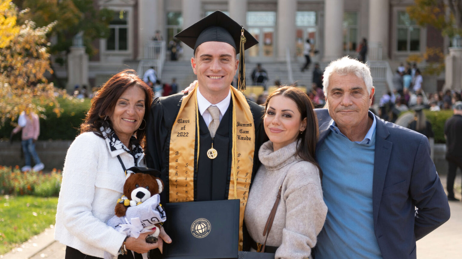 Gabe Giusti poses with his family after accepting his diploma at Purdue Global’s October 2022 commencement in West Lafayette. (Purdue University photo/John Underwood)
