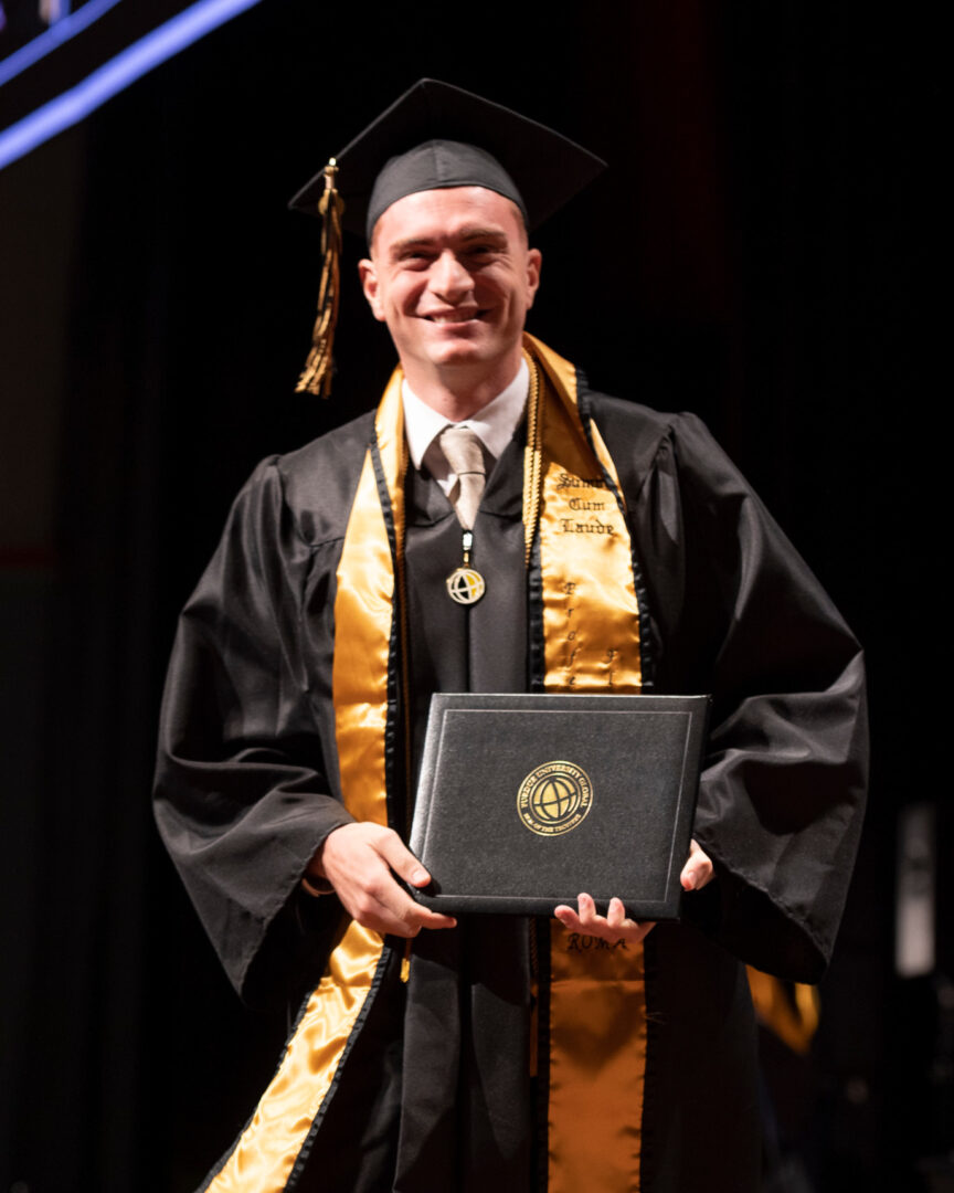 Gabe Giusti took an extra class for several consecutive semesters so that he could participate in the same commencement ceremony as his friend, Massimo Ruzza. (Purdue University photo/John Underwood)