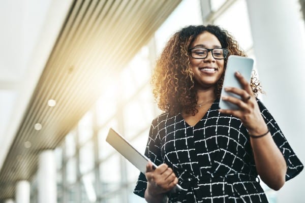 A woman looks at her mobile phone